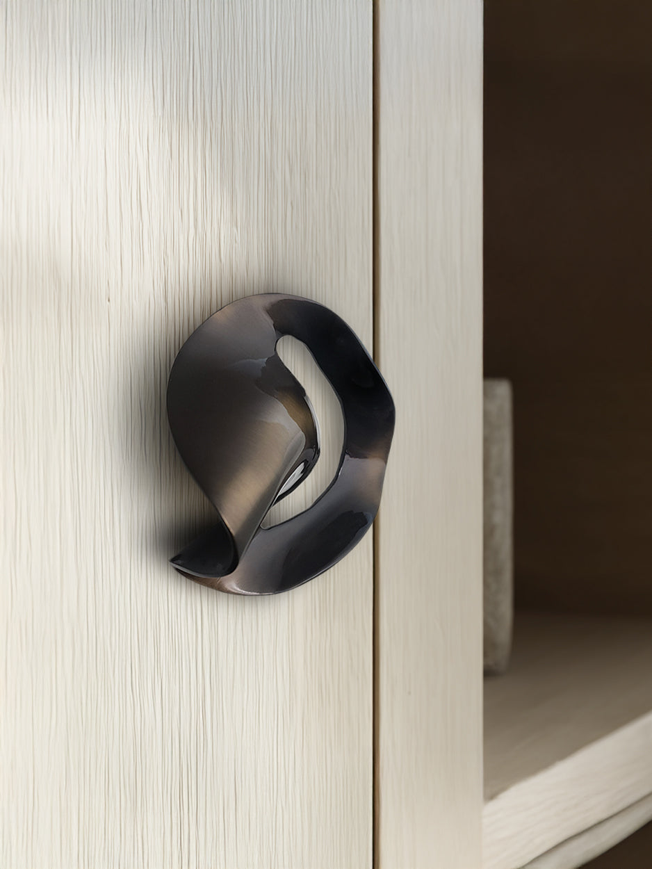 Modern bronze door handle on a light wood door