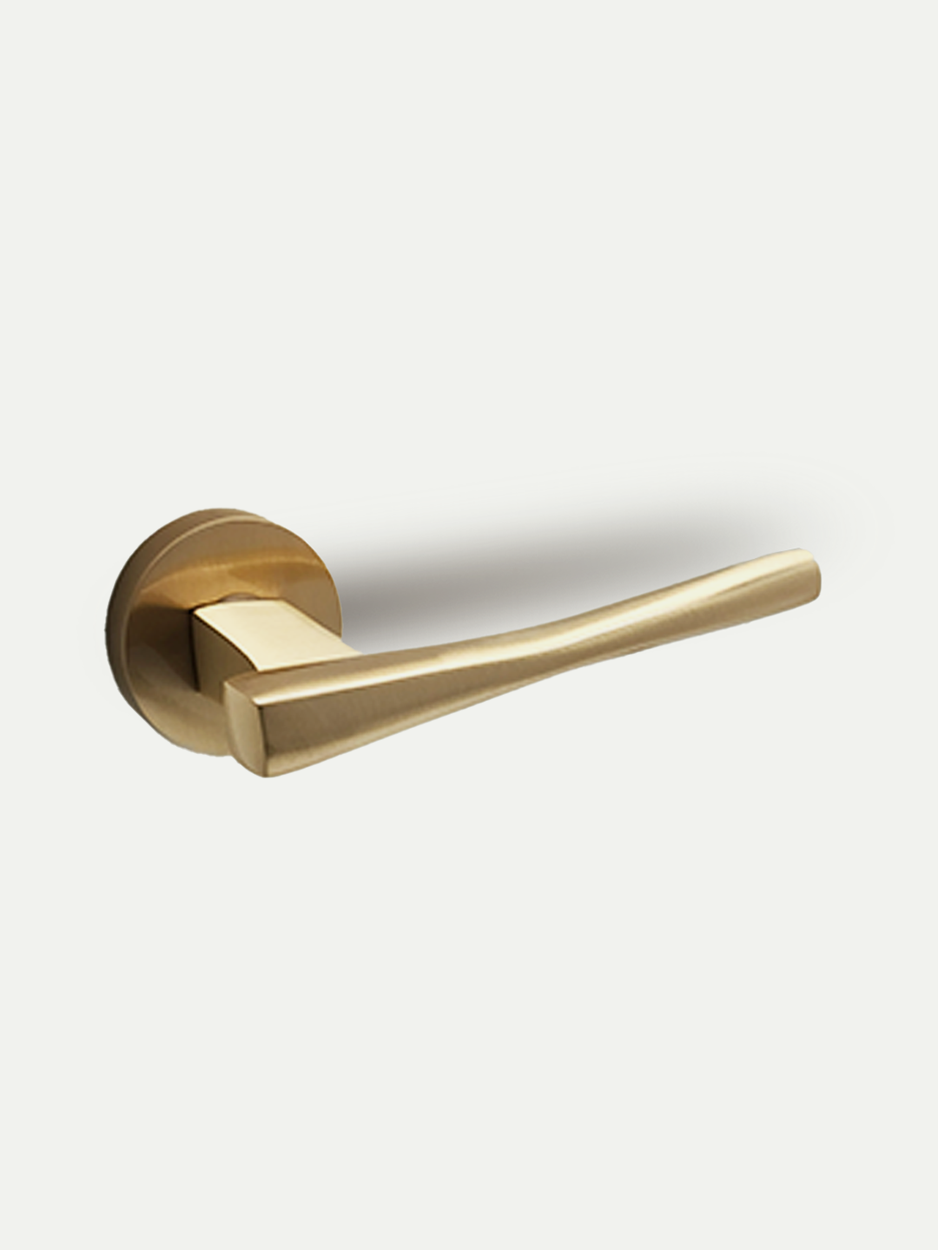 A sleek contemporary brushed brass lever handle with a round rose mounting for bedroom and bathroom doors