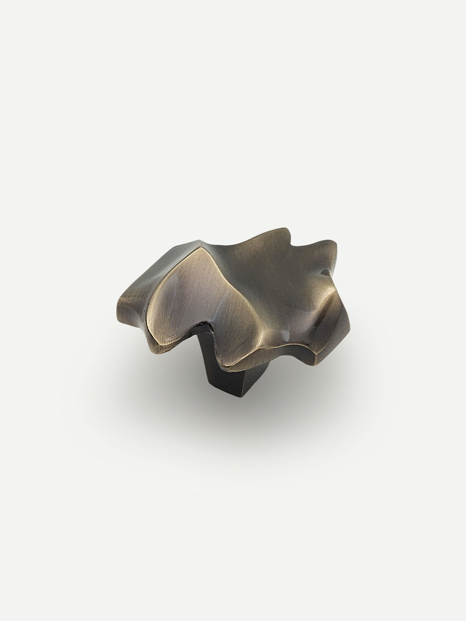 Nexus Cabinet Pull in a glossy bronze finish, featuring an abstract and modern design that adds a chic and luxurious touch to cabinets, dresser drawers, and bar cabinets.