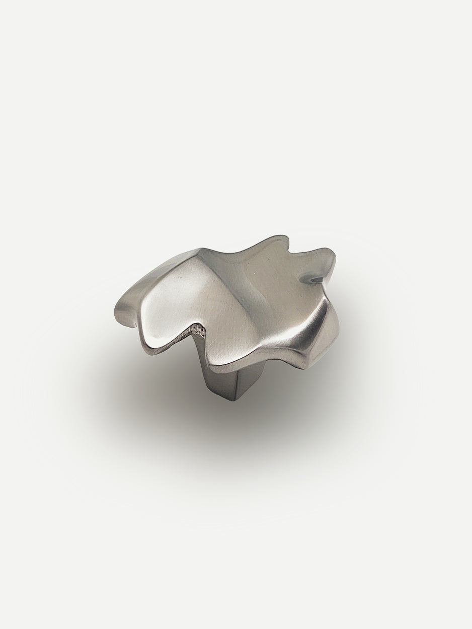 Nexus Cabinet Pull in a satin nickel matte finish, showcasing its sleek, abstract design and elegant form, perfect for enhancing the style of cabinets, dresser drawers and bar cabinets.