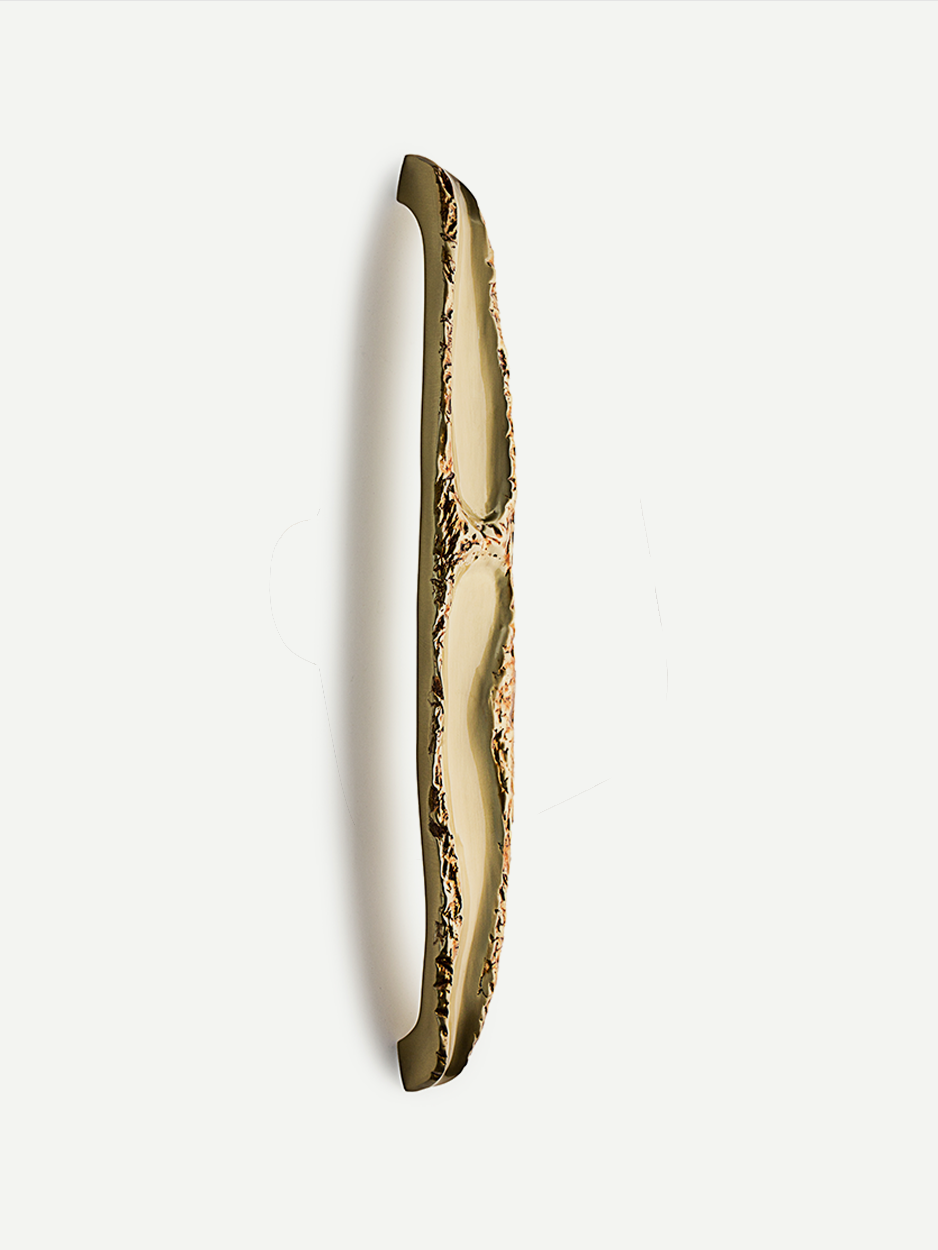 Handcrafted designer door handle in luxury brass
