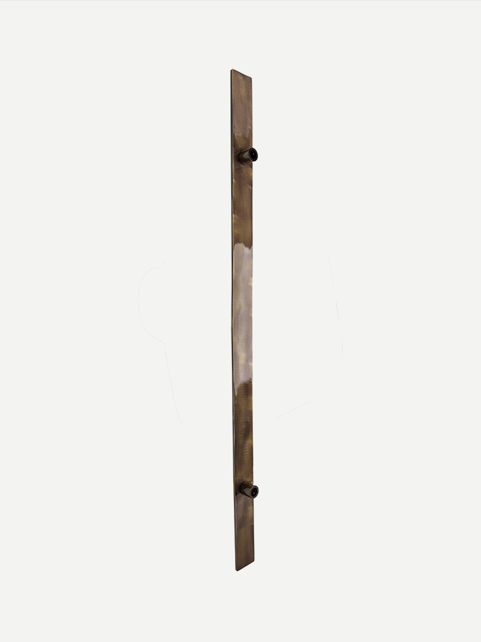 Slim elongated pull handle for double front doors in brass.