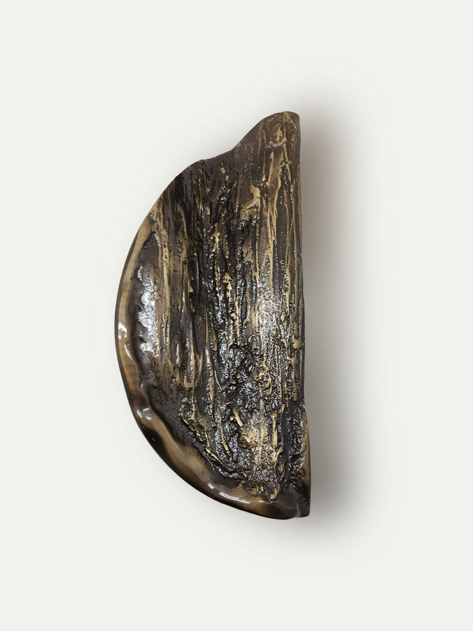 Designer dual door handles in solid brass with textured folded pattern for luxury interiors in bronze finish.