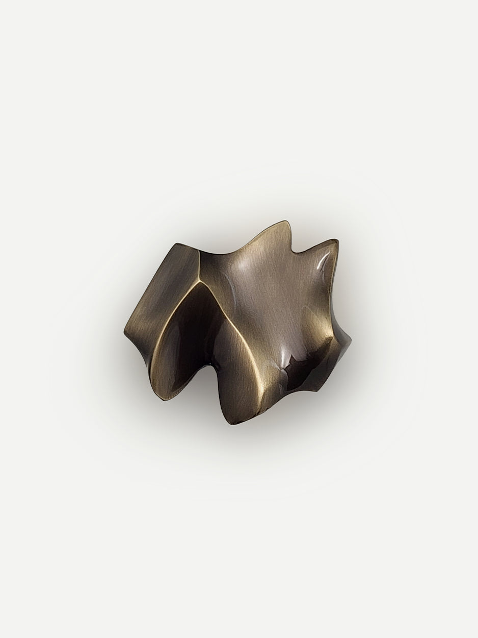 Nexus Cabinet Pull in a glossy bronze finish, featuring an abstract and modern design that adds a chic and luxurious touch to cabinets, dresser drawers, and bar cabinets.