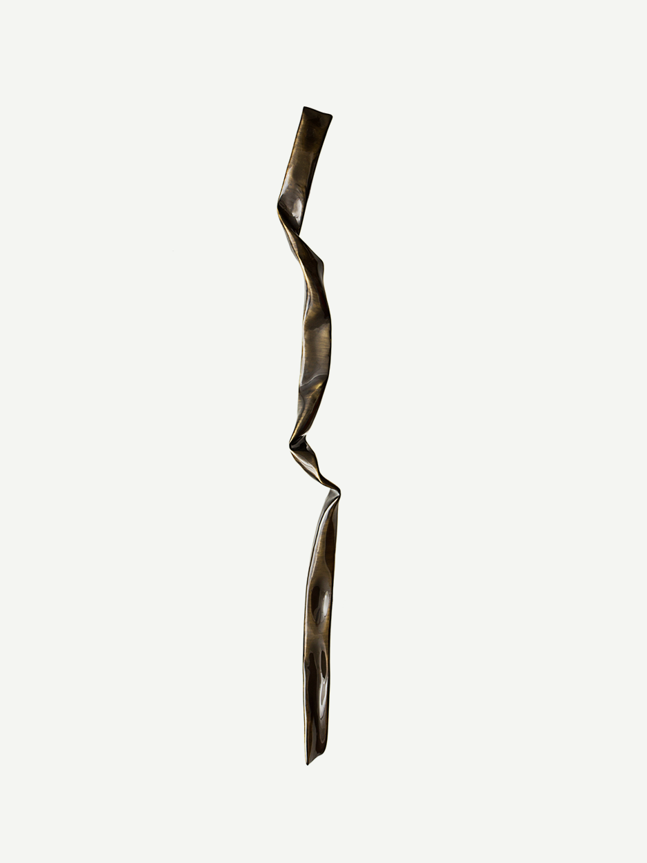 SPRIG door handle in glossy bronze finish. This image highlights the handle’s unique design, crafted to resemble the intricate folds of crinkled paper in solid brass. The glossy bronze finish adds a touch of elegance and sophistication, making it a standout piece for luxury homes. The handle’s long form and artistic texture bring a modern yet vintage vibe to any entrance. 