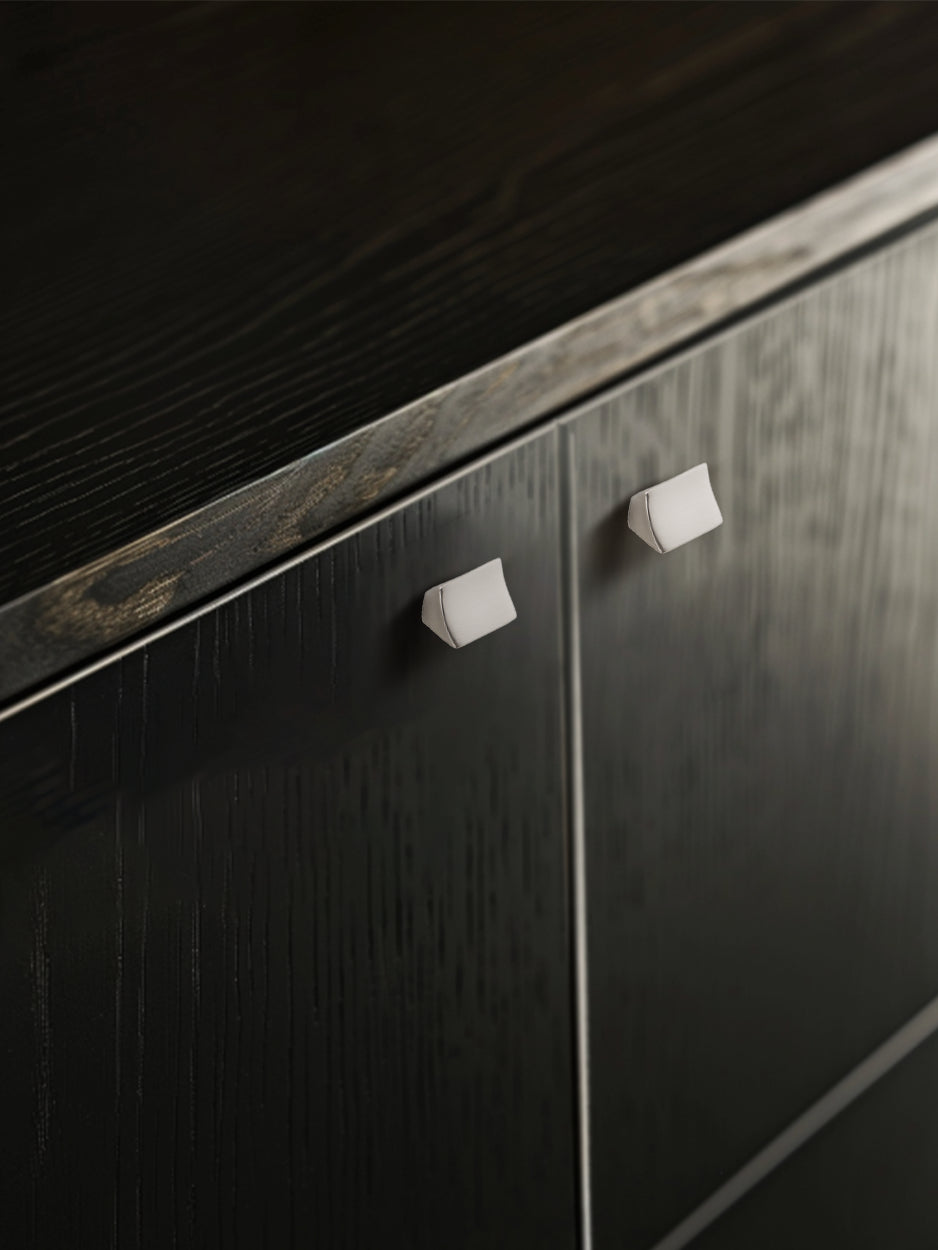 Mockup image of the Satellite cabinet knob installed on furniture, showcasing its fluid geometry and concave surface, perfect for enhancing the decor of personal and professional spaces, including study and commercial furniture.