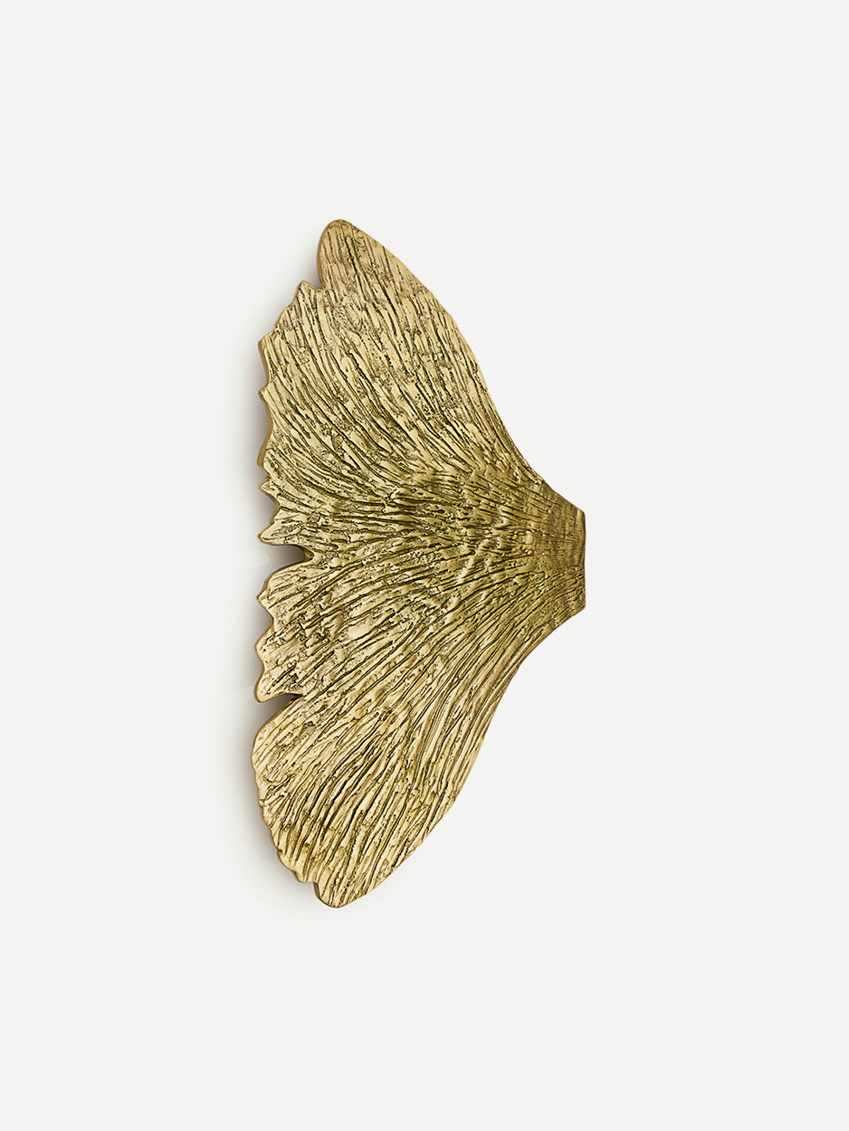 Close-up of the ICARUS door pull in a brushed brass finish, highlighting the intricate wing-inspired design that adds elegance and a sense of freedom to luxury front entryways.