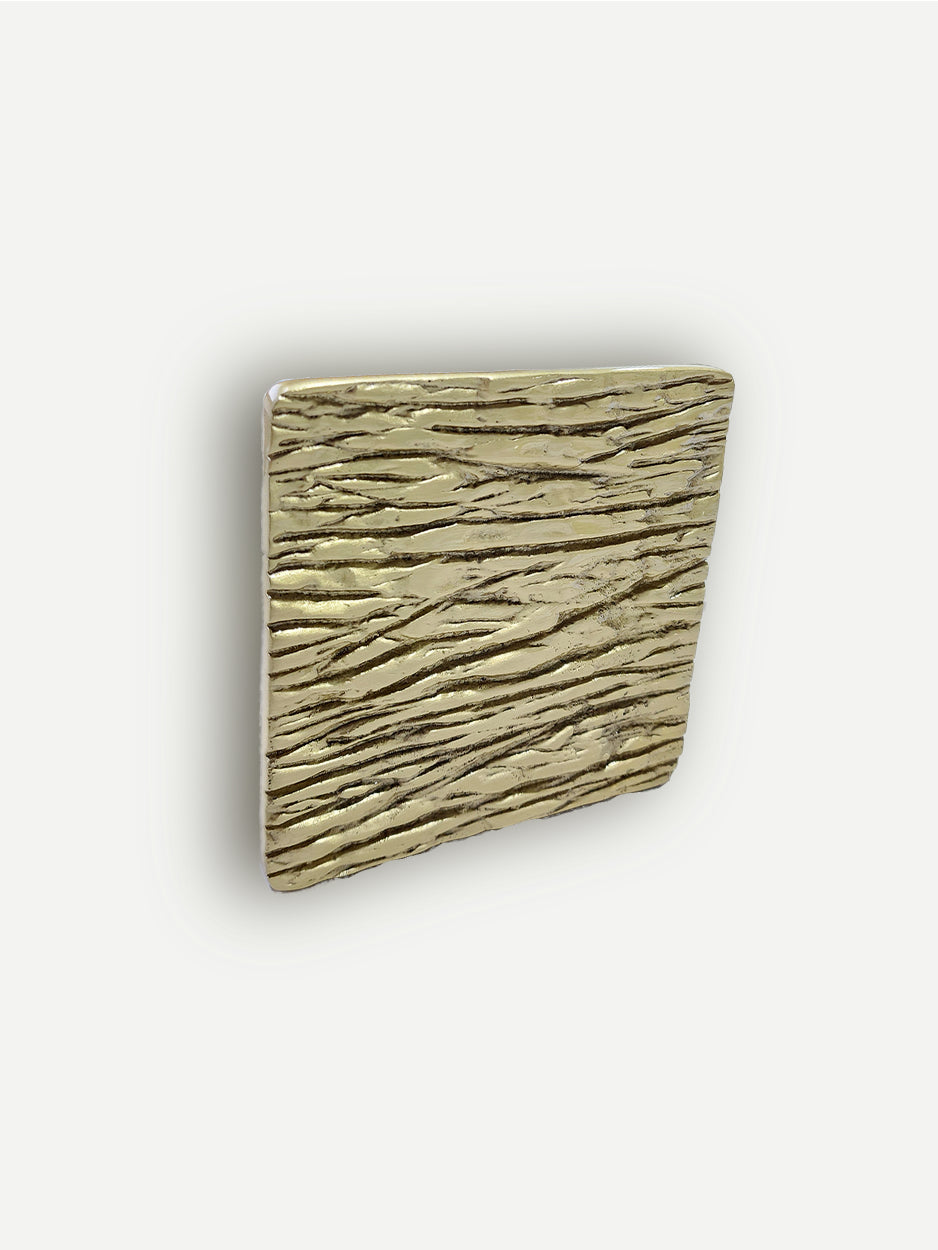 Textured cabinet pull in brushed brass finish, designed to evoke the look of willow tree bark and branches, combining natural inspiration with a modern, elegant finish.