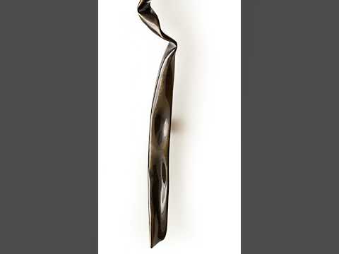 SPRIG door handle in glossy bronze finish. This image highlights the handle’s unique design, crafted to resemble the intricate folds of crinkled paper in solid brass. The glossy bronze finish adds a touch of elegance and sophistication, making it a standout piece for luxury homes. The handle’s long form and artistic texture bring a modern yet vintage vibe to any entrance. 