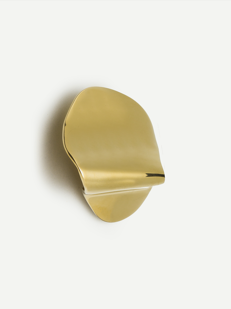 Image of a brass cabinet pull in a gold PVD finish, demonstrating its sophisticated elegance and decorative flair. Perfect for use on dresser drawers, nightstands, and kitchen cabinets.