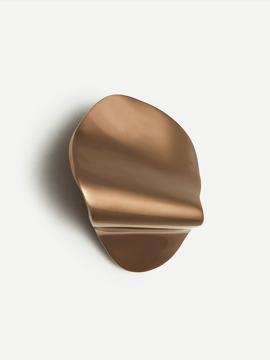 Image of a brass cabinet pull in a rose gold PVD finish, highlighting its unique design and luxurious appeal. Suitable for dresser drawers, nightstands, and kitchen cabinets.