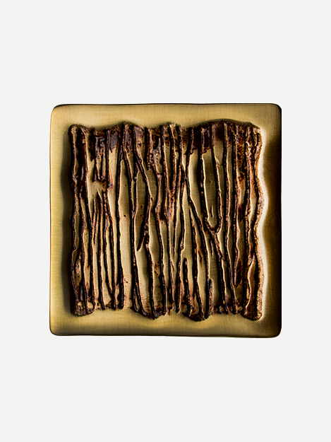 Close-up image of a luxury square cabinet pull in POV finish with curved minimal border and vertical striations, inspired by banyan tree roots. Ideal for modern and traditional decor styles.