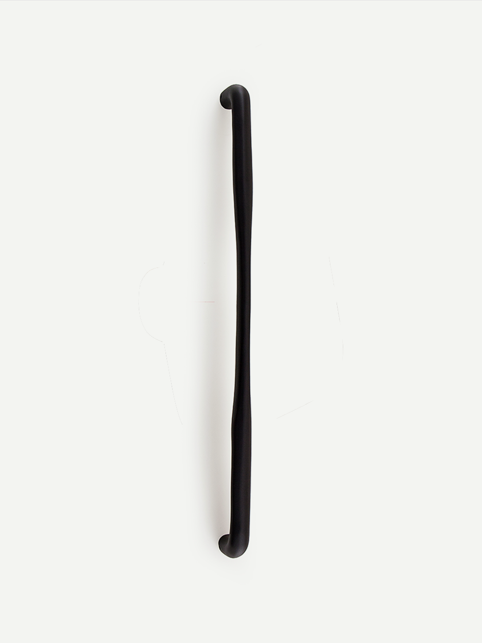 BATON door handle in a black matte finish, emphasizing its minimalistic design with a tapered center. The handle adds a sophisticated and modern touch to contemporary interiors.