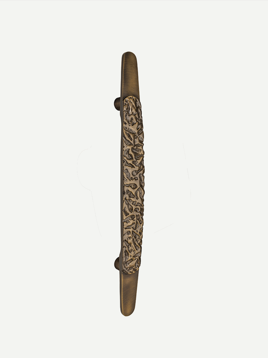 CORAL main door pull in glossy bronze finish, highlighting its textured center and elegant, artistic design. The bronze finish enhances the handle's luxurious appeal, perfect for upscale residences.