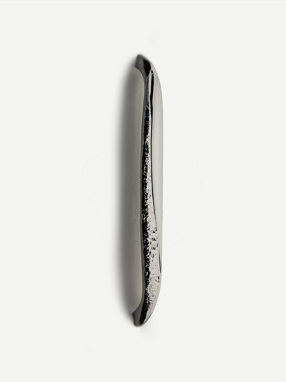 Luxury front door pull in a chrome finish, emphasizing the striking contrast between its minimal smooth sections and the abstract, textured areas, making it a standout piece for modern entrances.