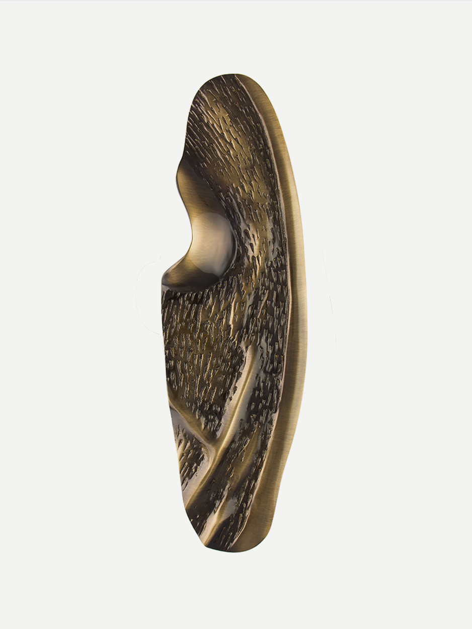 Front view of the fluid sculpted front door pull in a glossy bronze finish, showcasing its free-flowing, abstract design and textured facets, perfect for adding luxury to any home entrance.