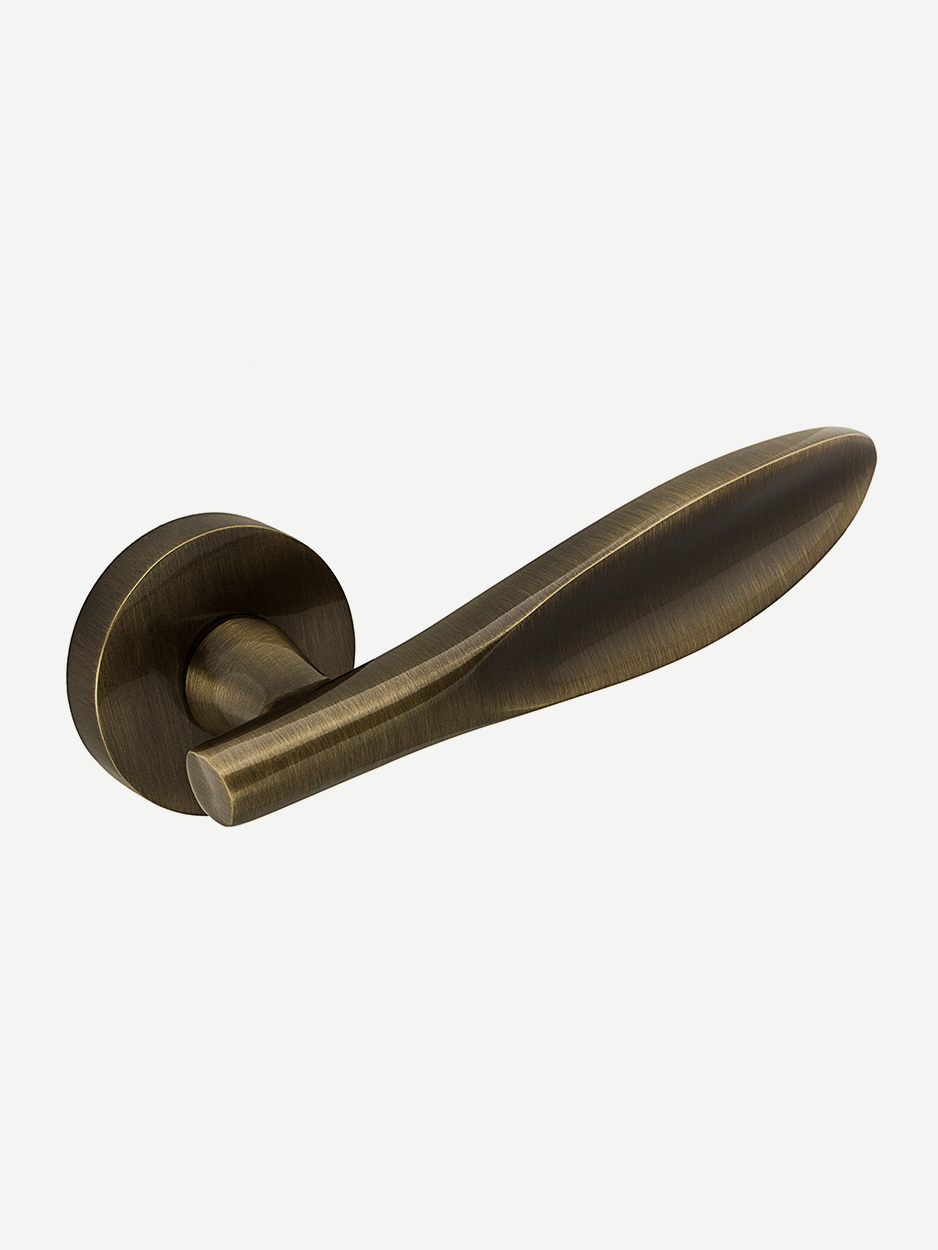 Image of the Ovoid Lever Handle in antique brass finish. The petal-shaped design adds a touch of whimsy and class, perfect for enhancing interior décor with a blend of luxury and character.