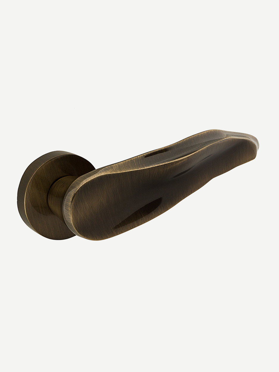 Image of the Orphic Lever Handle in glossy bronze finish. Entrancing and elegant, this lever handle adds an ultra-luxe touch to any door, enhancing your space with its exquisite design.