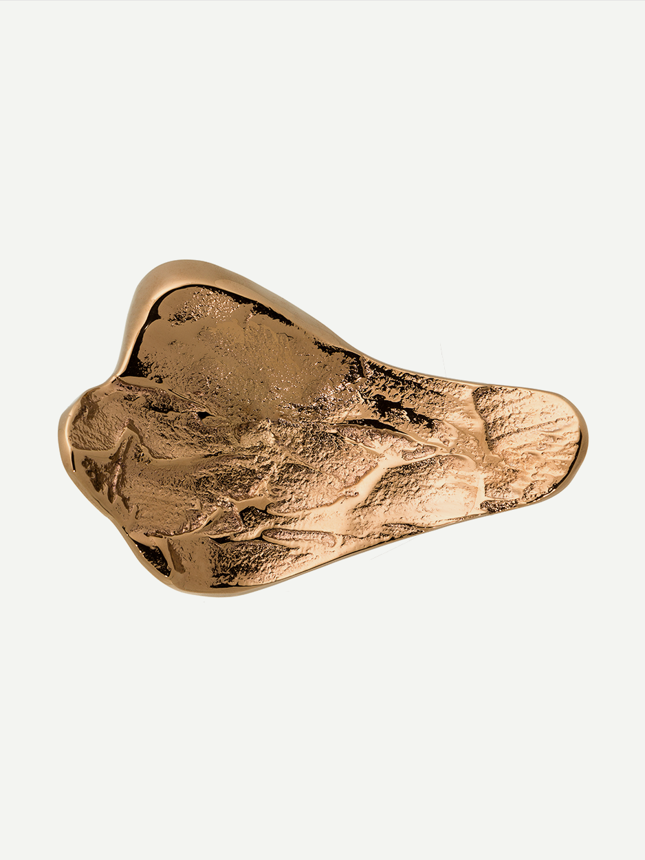 Textured cabinet and drawer pull in Rose Gold PVD, designed with intricate details inspired by natural lava flows. Offers a unique and elegant aesthetic to your home decor.