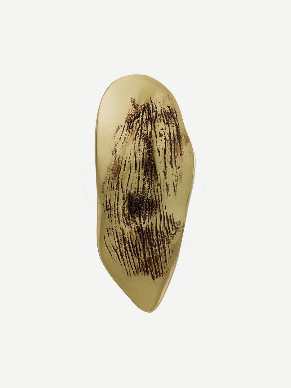 Textured cabinet and drawer pull in a Gold PVD finish, shaped like a leaf and inspired by natural lava flows. This luxuriously handcrafted piece adds an artistic and serene touch to your home interiors.