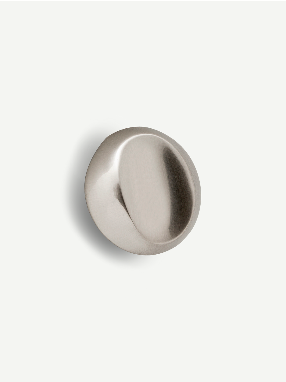 Satin nickel Nebula cabinet knob with a sleek, cloud-like design, ideal for enhancing the aesthetic of dresser drawers and cabinets in modern interiors.