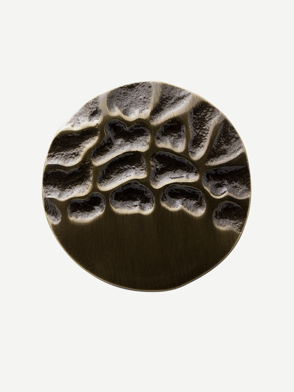 Close-up of the knob in a glossy bronze finish, featuring a textured design that enhances cabinets and drawers with individuality and uniqueness, ideal for interiors embracing biophilic design and nature-inspired decor.