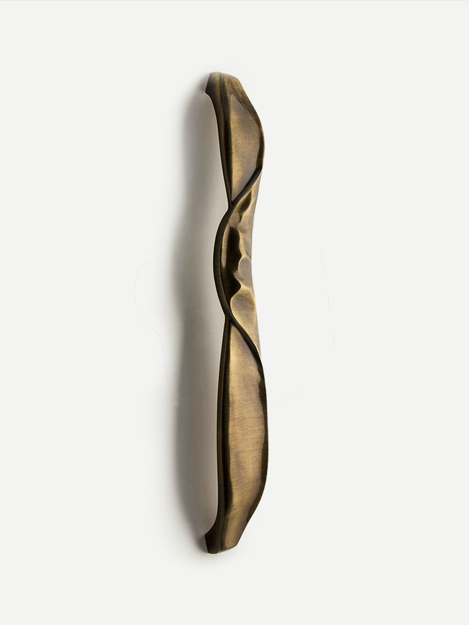 Contemporary sculpted door handle in solid brass