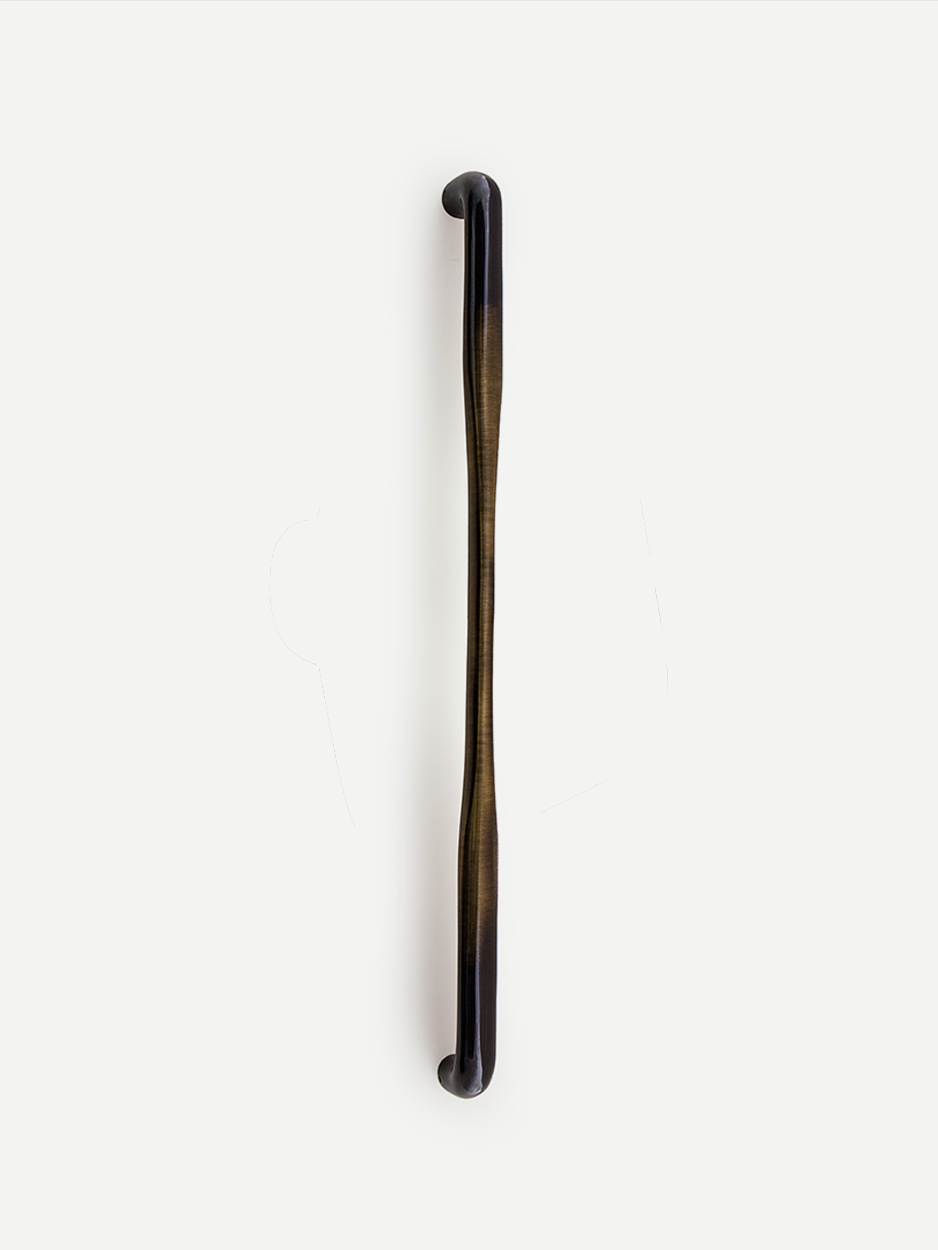 Linear entryway pull handle with minimalist form in bronze.